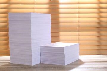 Stacks of paper sheets on wooden table