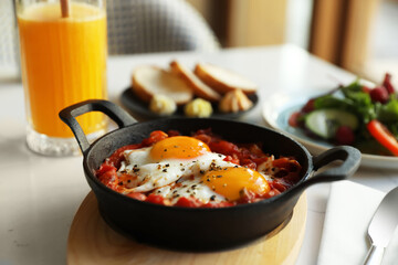 Tasty Shakshouka served on white table, closeup. Traditional Arabic dish