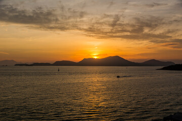 Naklejka na ściany i meble Sunset over the sea at the coast of Angra dos Reis town, State of Rio de Janeiro, Brazil. Photo taken with Nikon D7100, 18-200 lens, at 29mm, 1/125 f 6.3 ISO 100. Date: Dec 28, 2016