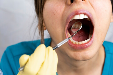 young female dentist holding dental instruments in her hand