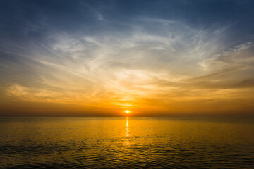 Fototapeta premium sunset sky with dramatic sunset clouds over the sea. Beautiful sunrise over Ocean