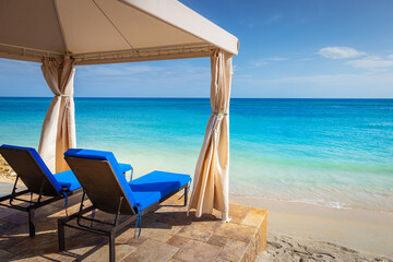Fototapeta na wymiar Caribbean beach with gazebo and lounge chairs, Montego Bay, Jamaica