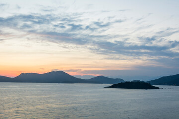 Fototapeta premium Sunset over the mountains at the coast of Angra dos Reis town, State of Rio de Janeiro, Brazil. Photo taken with Nikon D7100, 18-200 lens, at 32mm, 0.6 sec f 11 ISO 100. Date: Dec 28, 2016