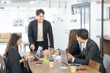 Selective Focus. Business presentation. project manager pointing at desktop presenting statistical data, briefing diverse group of employees. demonstrates statistics.