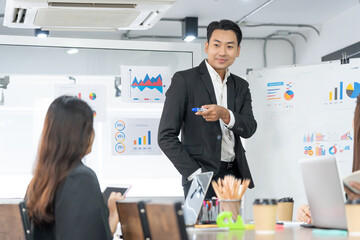 Selective Focus. Business presentation. project manager pointing at desktop presenting statistical data, briefing diverse group of employees. demonstrates statistics.