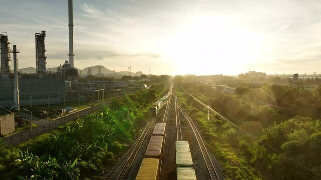 Freight train with Containers Cargos near Oil Refinery Plan back ground, Freight service forwarding and Logistics transportation Industry concept