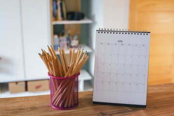 Calendar 2022 desk place on the table. Desktop Calender for Planner to plan agenda, timetable, appointment, organization, management each date, month, and year on wooden office table. Calendar Concept - obrazy, fototapety, plakaty