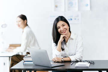 Asian woman working with laptop in her office. business financial concept.