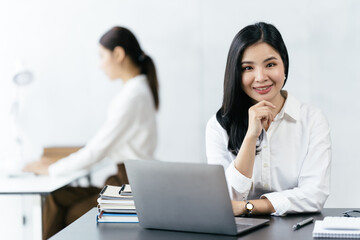 Asian woman working with laptop in her office. business financial concept.