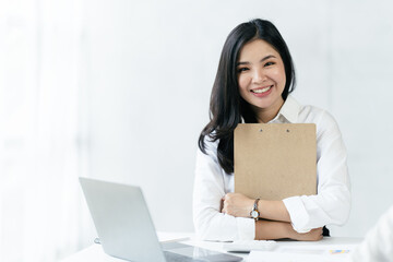 Asian woman working with laptop in her office. business financial concept.