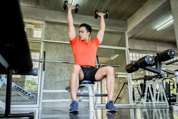 Obraz premium man asian hold dumbbell weight exercise, fitness, gym, body strong, for health, sport bodybuilder training strength, lifestyle.