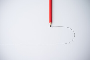 Flat lay of red pencil draw turning point arrow line on white background. Business, financial and...