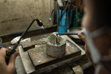 Jeweler at work in jewelry. Desktop for craft jewelry making with professional tools. Close up view of tools. Thailand. 