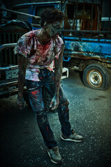 bloodied zombie by a car
