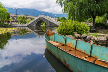 Ancient stone arch bridge and lotus pond in Dali Park, Yunnan Province, China	