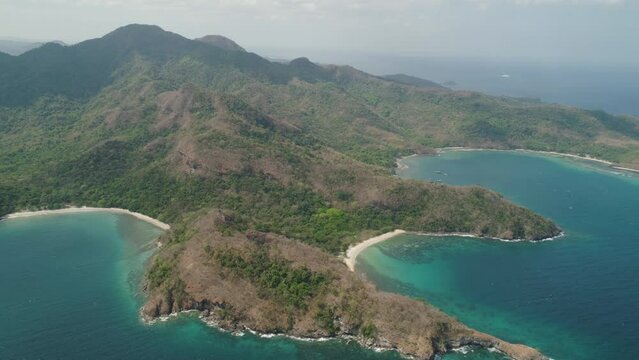 Aerial view coastline with tropical beach, island Limbones, lagoons and coral reefs. Neela cove, Philippines, Luzon. Coast ocean with turquoise water. Tropical landscape in Asia.