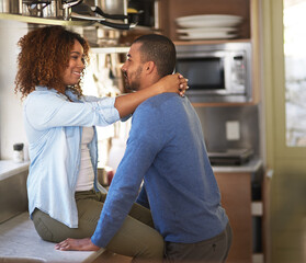 If we carry on well never get dinner done. Shot of a young couple sharing a romantic moment in the kitchen.