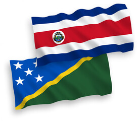 Fototapeta premium National vector fabric wave flags of Republic of Costa Rica and Solomon Islands isolated on white background. 1 to 2 proportion.
