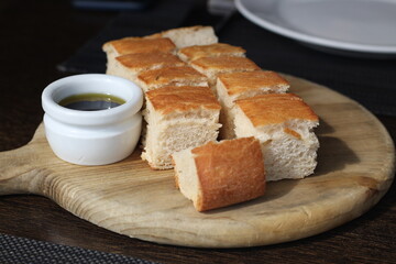 Close up of delicious bread on wooden plate with olive oil and vinegar, Hong Kong, Soft Focus