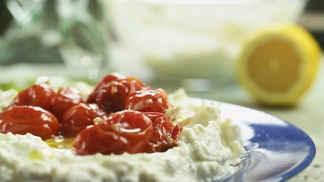 Eating Whipped Feta Dip With Roasted Cherry Tomatoes.
