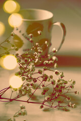 Vintage blurred  toned still life with  cup of coffee or tea and dry flowers, shadow, minimal still life retro aesthetics