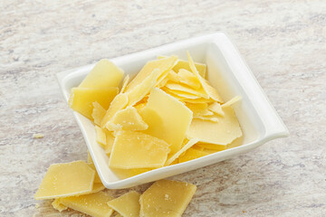 Sliced parmesan cheese heap in the bowl