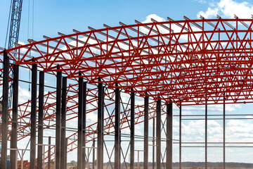Installation of metal trusses and frame during the construction of an industrial building or...