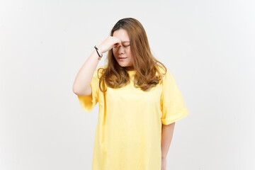 Obraz na płótnie Canvas Suffering Headache of Beautiful Asian Woman wearing yellow T-Shirt Isolated On White Background