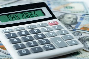 Tax 2023. calculator with 2023 on display. Income Statement. paying tax rate. Taxation, taxes...