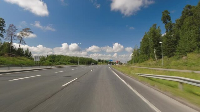 POV dash cam of driving under overpasses on Nordic summer highway