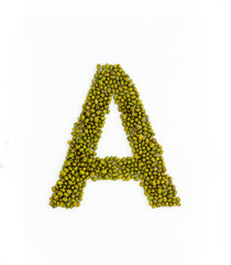 Capital letter A made from mung beans. Green mung bean font. Alphabet made from green gram . White background. Dry green maash seeds.