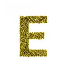 Capital letter E made from mung beans. Green mung bean font. Alphabet made from green gram . White background. Dry green maash seeds.
