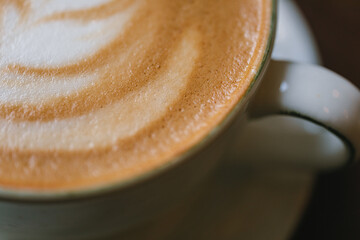 Cup of cappuccino with coconut milk. Macro shot. Selective focus.