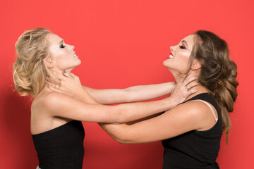 Two girls are fighting in the studio. Negative emotions, expression.