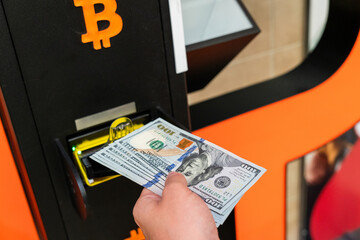 Atm machine bitcoin cryptocurrency. Usd hundred money payment on virtual crypto currency btc wallet. Woman withdraw american dollar bill money. Atm machine finance and technology concept.