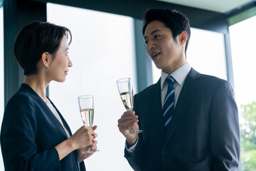 グラスを持ち話す日本人男女