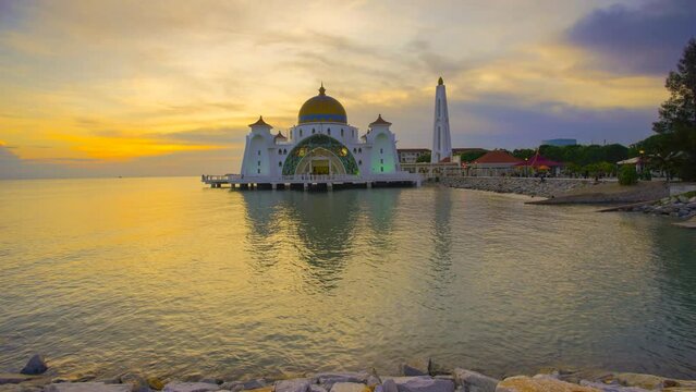 Time lapse 4k Footage of Beautiful Sunrise At Malacca Straits Floating Mosque, or Masjid Selat Melaka.  Tilt up effect