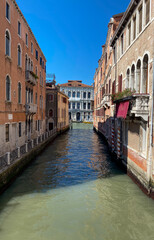 Fototapeta na wymiar The view of the calm narrow canal, Venice, Italy