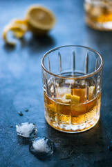 glass of whiskey with a lemon and ice 