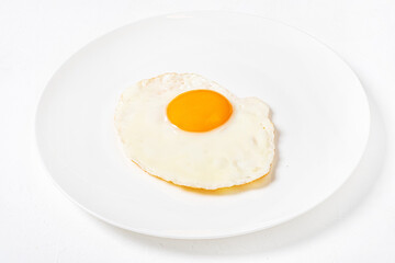 fried egg on the white plate