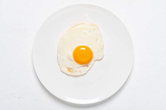 Fried Egg On The White Plate