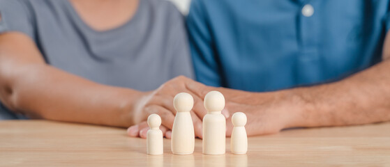Wooden peg dolls family, with man and woman couple. planning, saving family,  health care and...