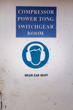 Caution sign to wear ear muff, the sound protective PPE which is showed on the door of engine switchgear room at the factory working place. Sign and symbol in industrial photo.