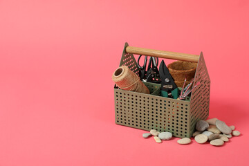 Gardening tools and accessories on pink background