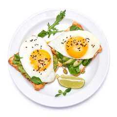 sliced avocado and fried egg on toasted bread isolated on white background