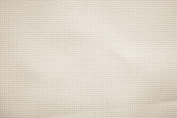 Fototapeta premium Fabric canvas woven texture background in pattern in light beige cream brown color.