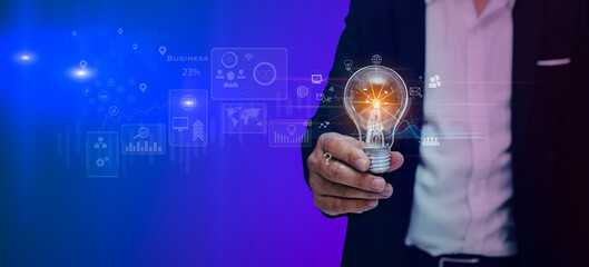 Double exposure of businessman hands holding light bulb with energy sources interface icons, Technology and ecology sustainable development concept.