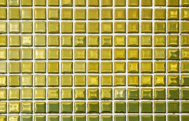 Gold yellow square mosaic tiles for ceramic wall and floor texture background in bathroom. Design golden pattern geometric with grid wallpaper decoration pool. Glass glitter seamless abstract surface.