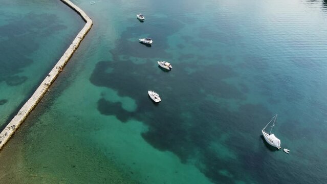 small motorboats anchored along the shore on the Adriatic Sea, stone coast landscape, blue sea, summer