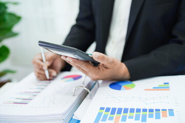 Business woman working and analysis with statistic graph in office.